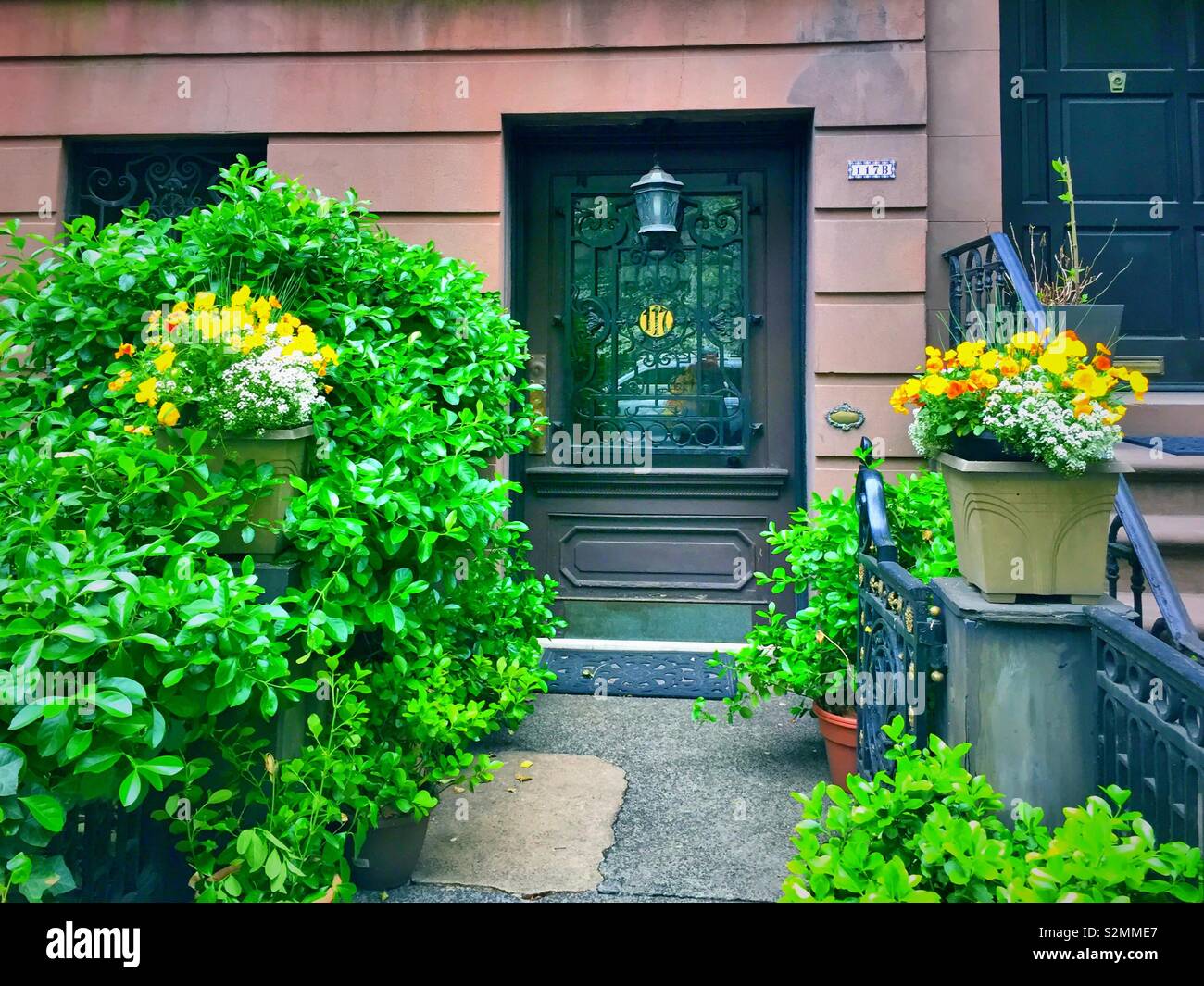 Beautifully landscaped front door an entrance to a brownstone in historic Murray Hill, NYC, USA - Smartphone Captured Stock Image
