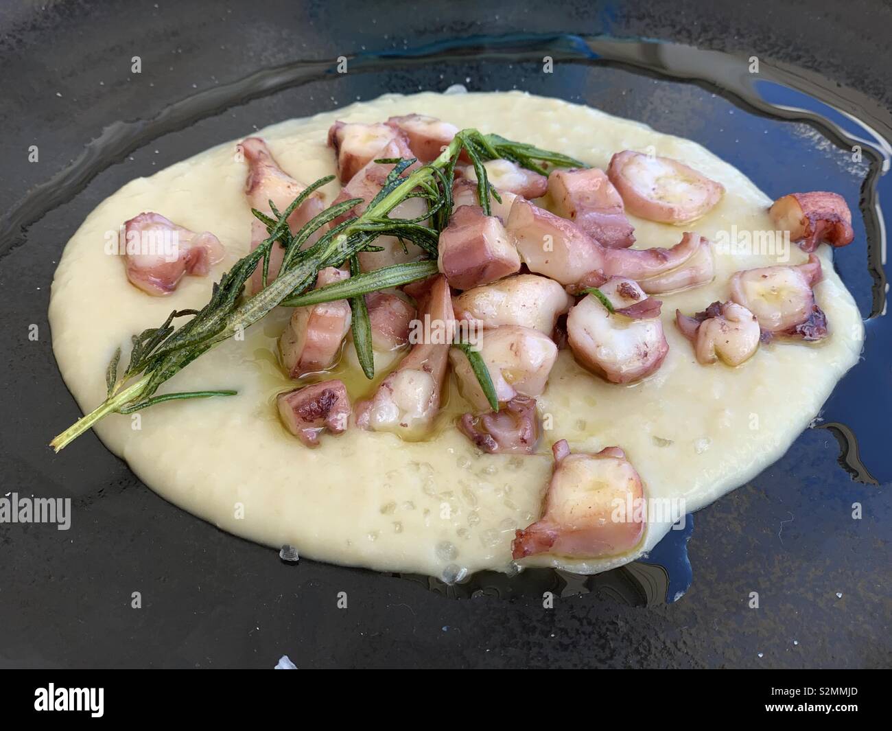 Octopus with chickpea sauce and rosemary Stock Photo