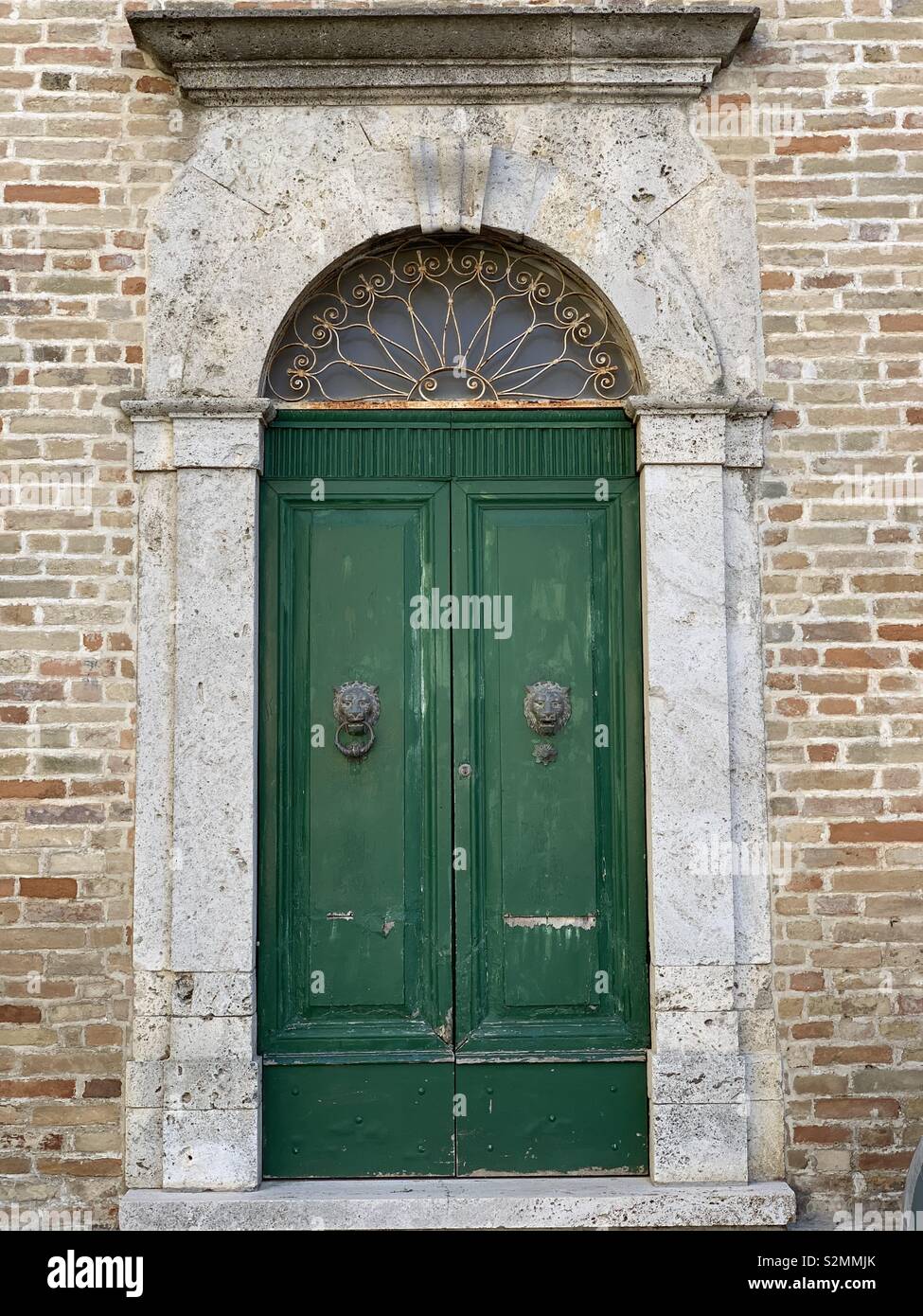 Old green wooden door, Cossignano, Ascoli Piceno county, Marche Region, Italy Stock Photo