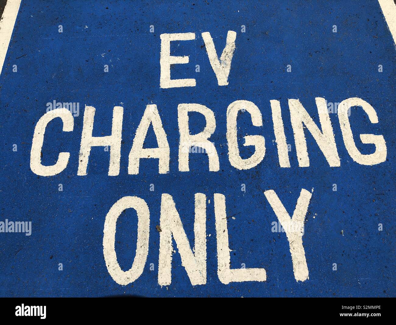 Parking bay painted sign denoting electric vehicle charging only - Smartphone Captured Stock Image