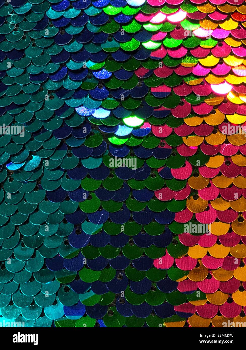 Shiny multi colored sequins in a fish scale pattern. - Smartphone Captured Stock Image