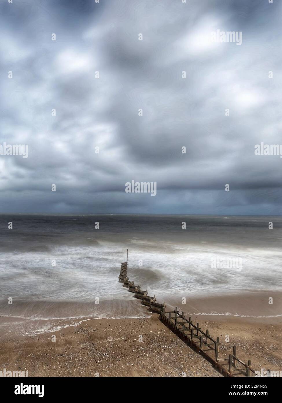 A long exposure of groynes at Overstrand in Norfolk Stock Photo