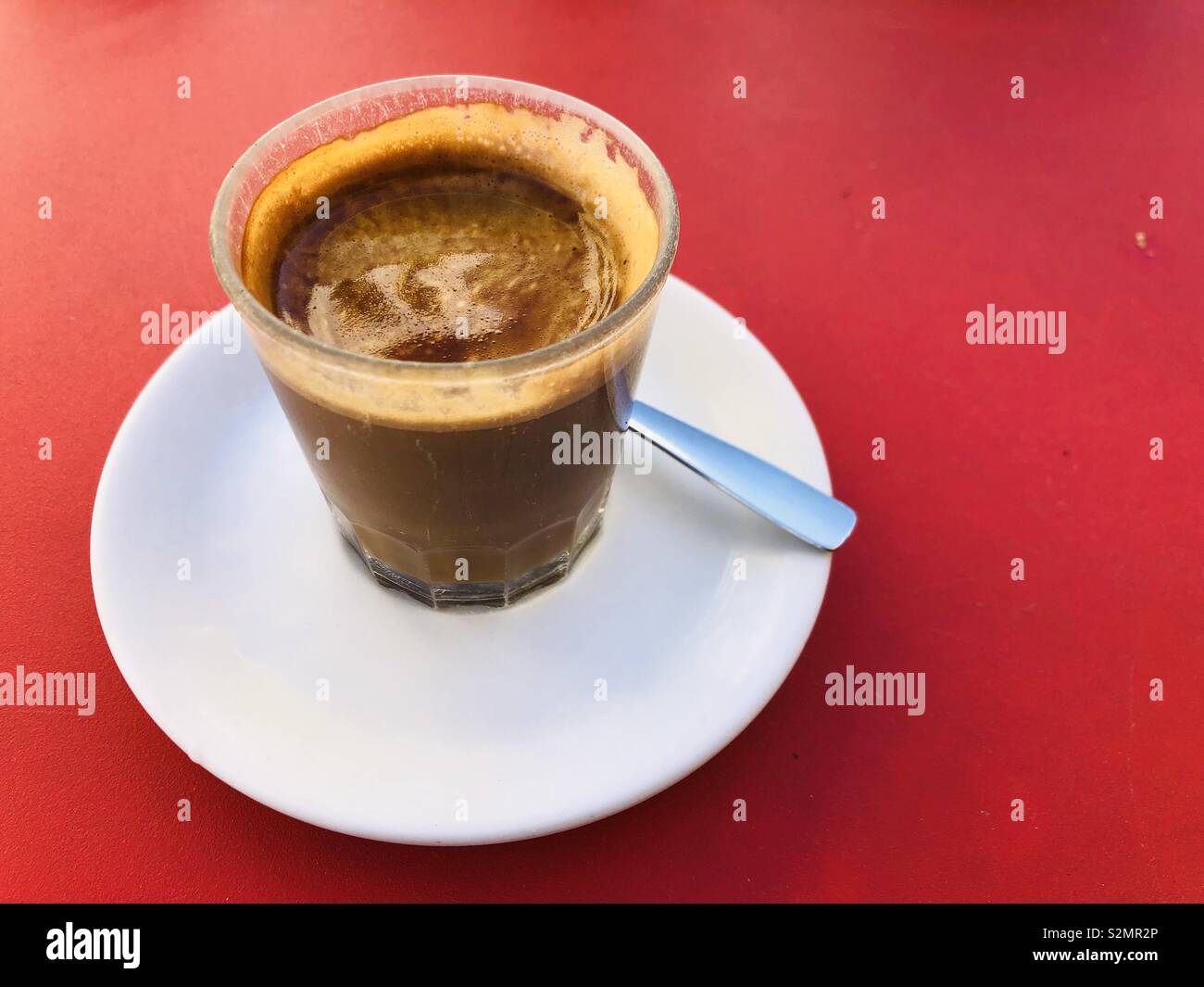 Spanish cortada coffee in red table - Smartphone Captured Stock Image