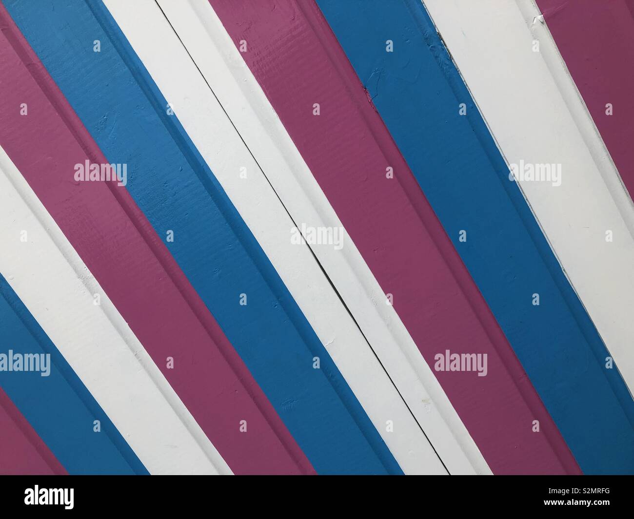 An image of the colourful striped pattern on a British seaside beach hut. - Smartphone Captured Stock Image