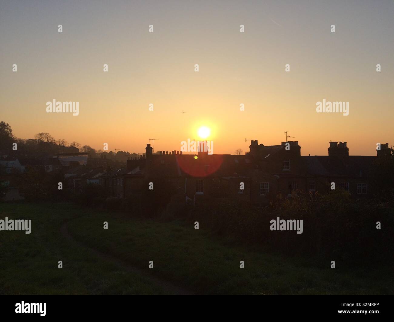 Sunset over houses in Harrow, London during the winter. Stock Photo