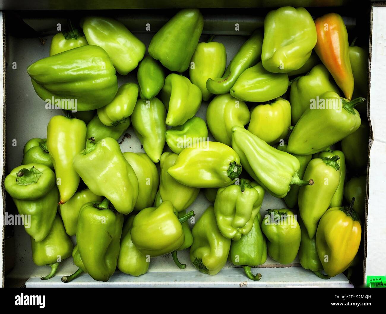 Green bell peppers in a box Stock Photo