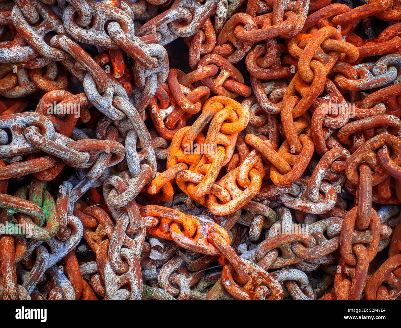 Rusty and orange coloured chain links, - Smartphone Captured Stock Image