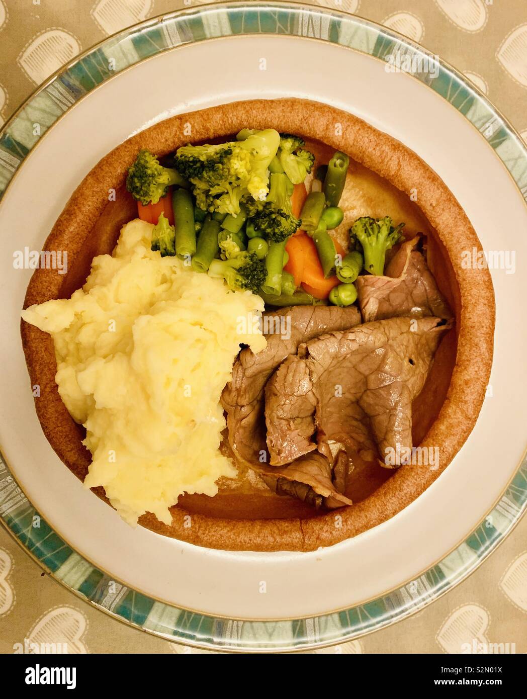 Roast dinner in a giant Yorkshire pudding. Stock Photo