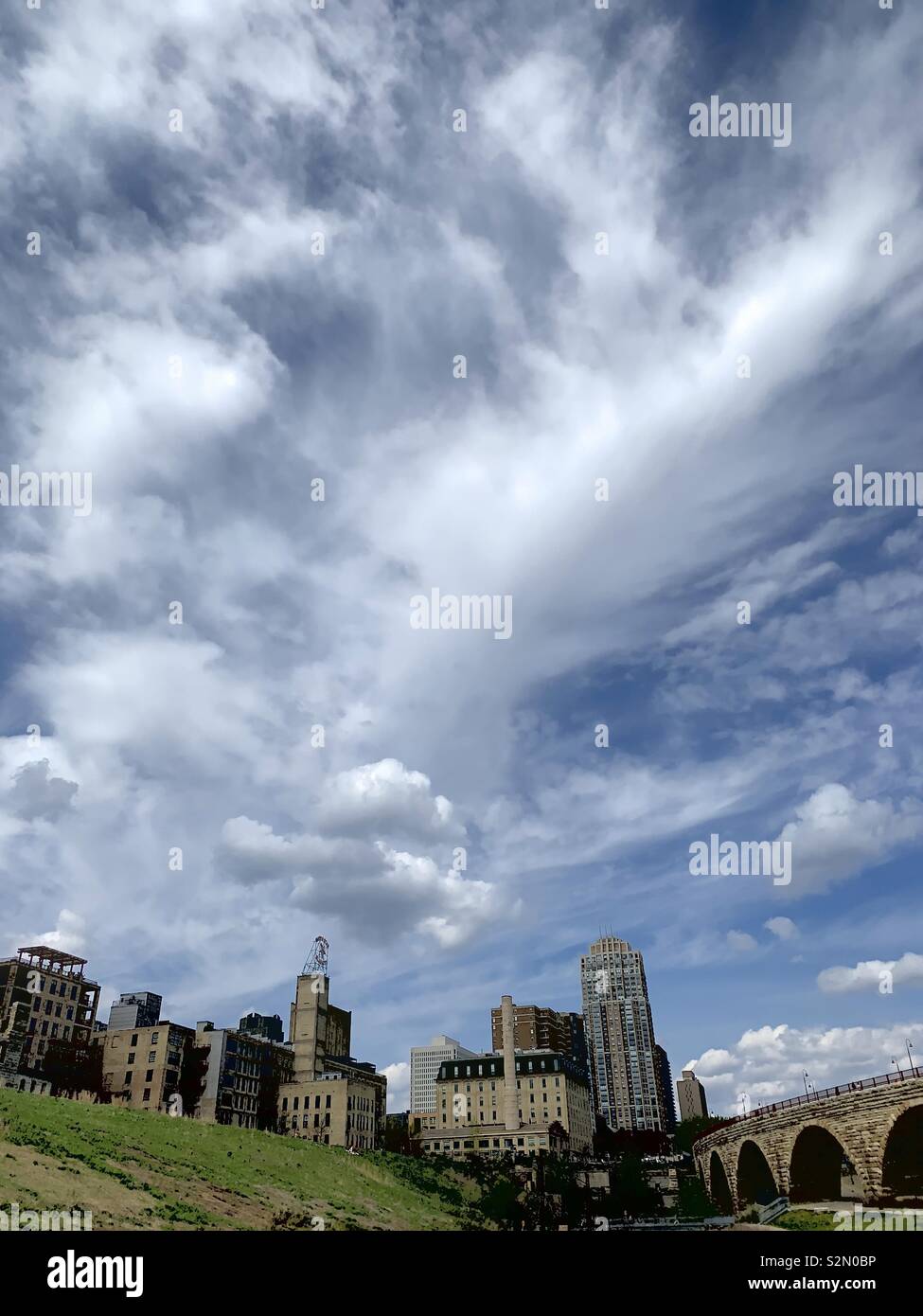 Cloudy spring afternoon with a city in the foreground. Stock Photo