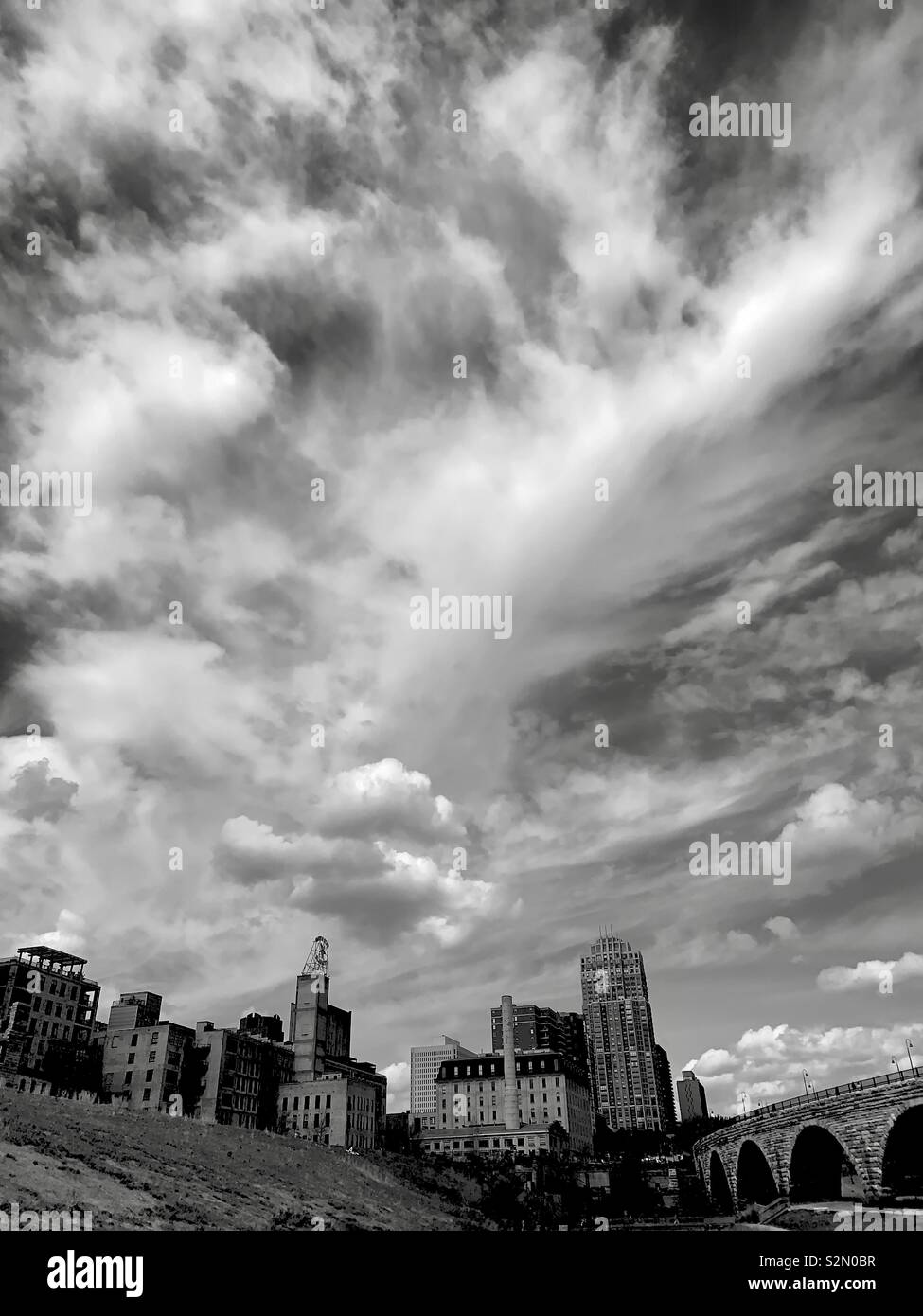 Cloudy spring afternoon with a city in the foreground. Stock Photo