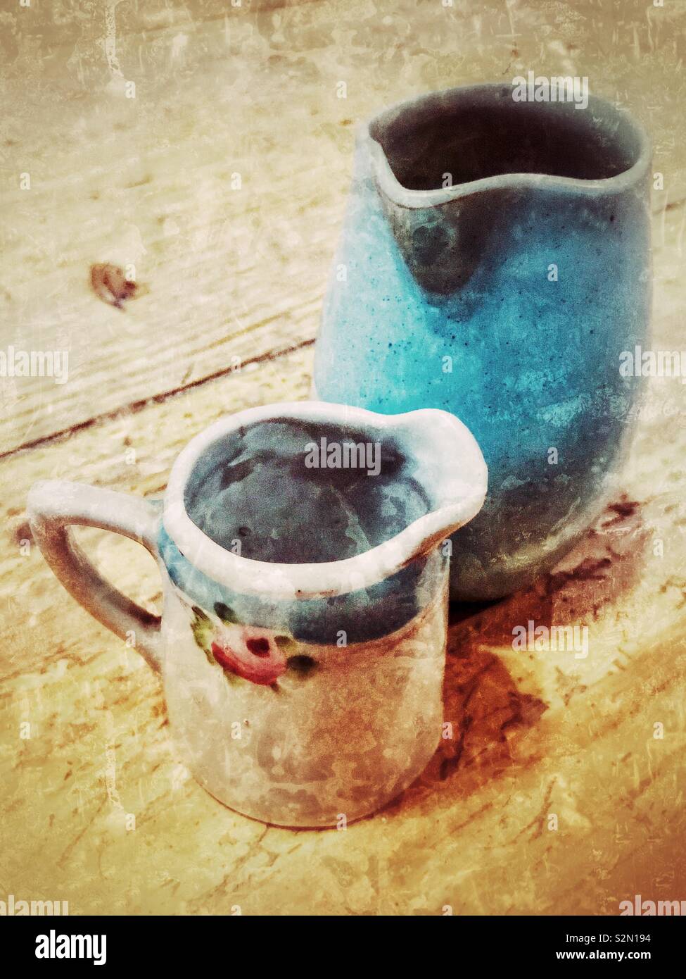 Two creamers in aqua shades, grunge Stock Photo