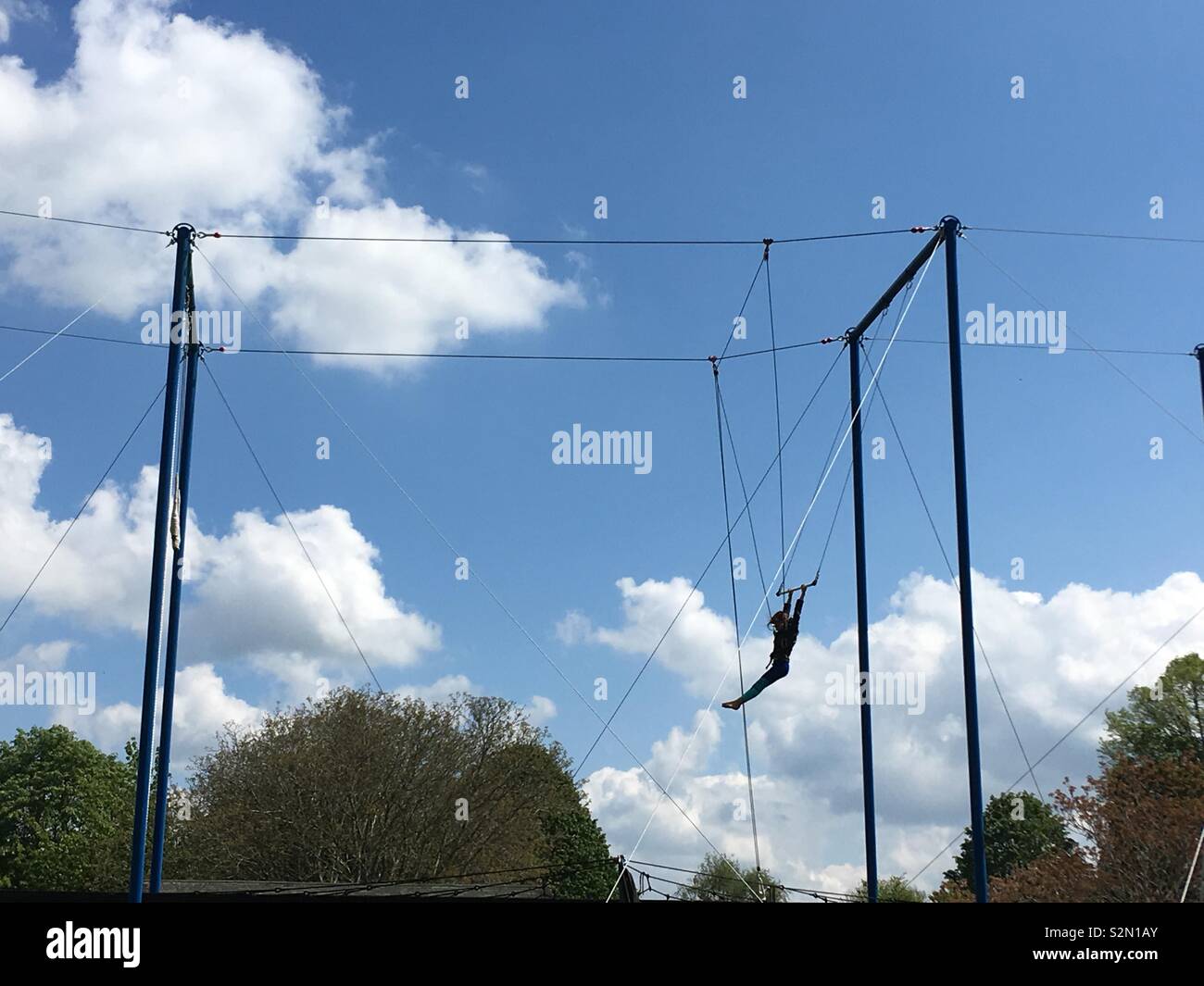 Trapeze artist silhouette in park - Smartphone Captured Stock Image