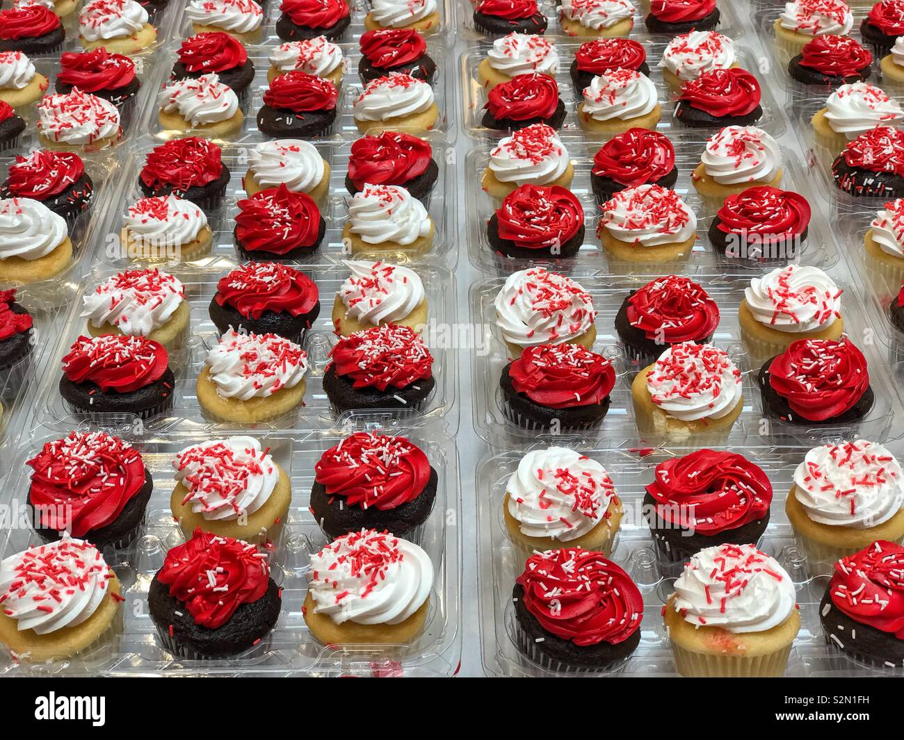Red and white iced muffins ready for a Canadian citizenship celebration. - Smartphone Captured Stock Image