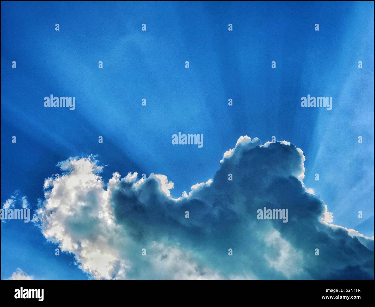 A classic example of Crepuscular Rays emanating from behind a silver lined cloud. This inspirational occurrence is also referred to as Splintered Light, sun beams,sun rays or God Rays. © COLIN HOSKINS - Smartphone Captured Stock Image