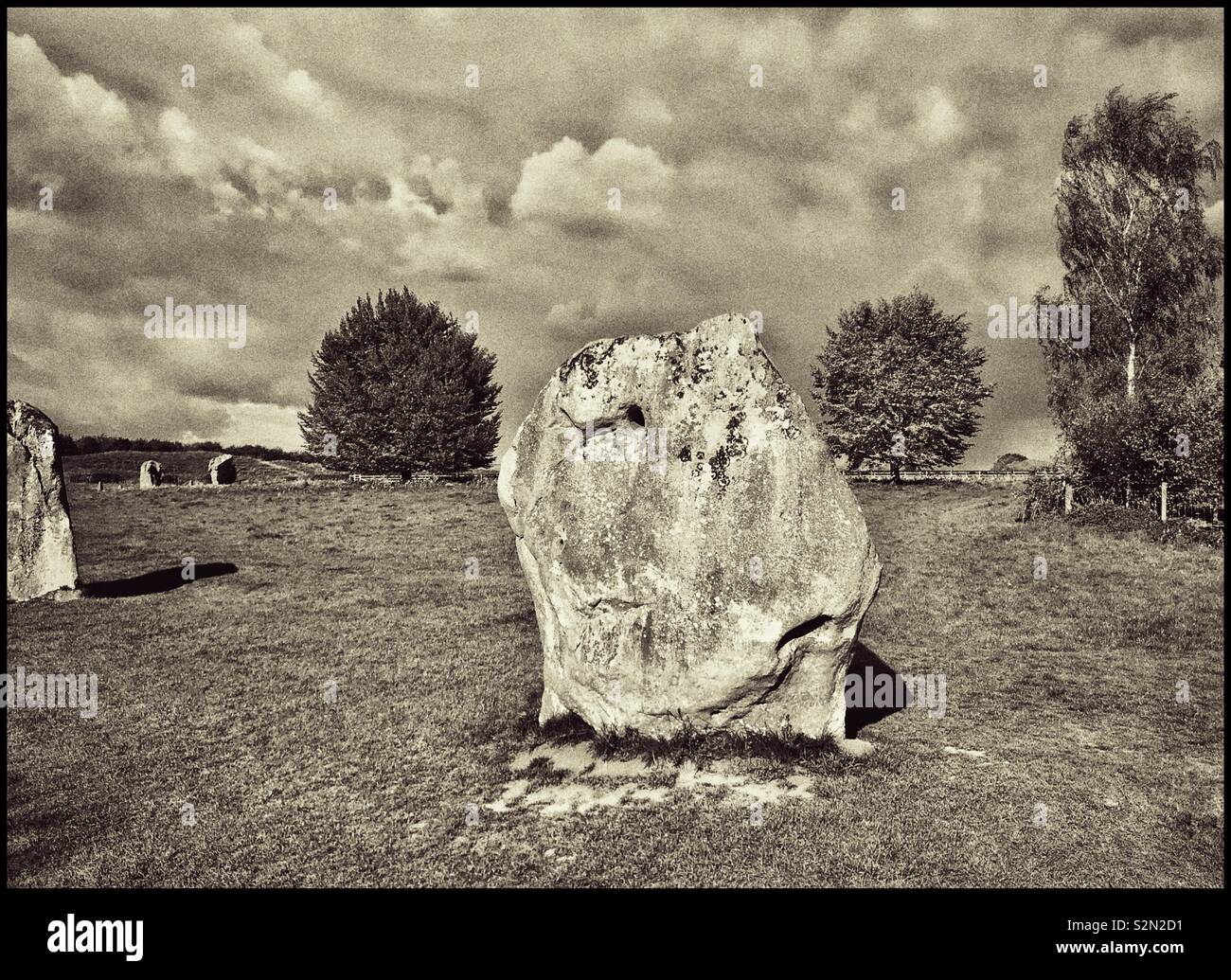 One of the shorter & squatter Ancient stones that form part of the Stone Circle in the N.W. Sector of Avebury in Wiltshire, England. The world’s largest Megalithic Stone Circle & UNESCO Heritage Site. - Smartphone Captured Stock Image