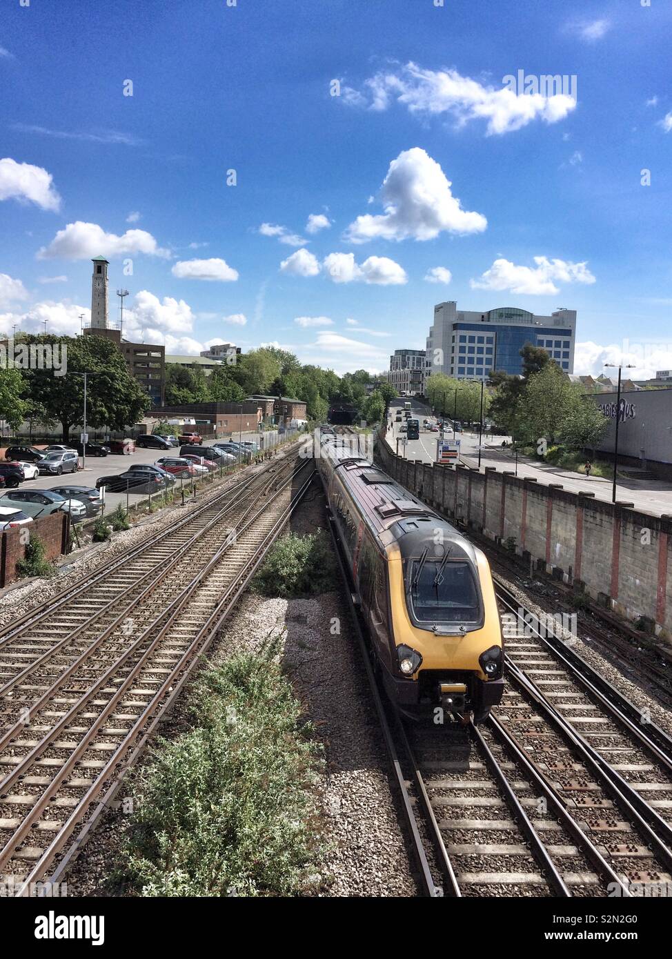 Train arriving at Southampton central station ,with view of civic center clock tower in the background - Smartphone Captured Stock Image