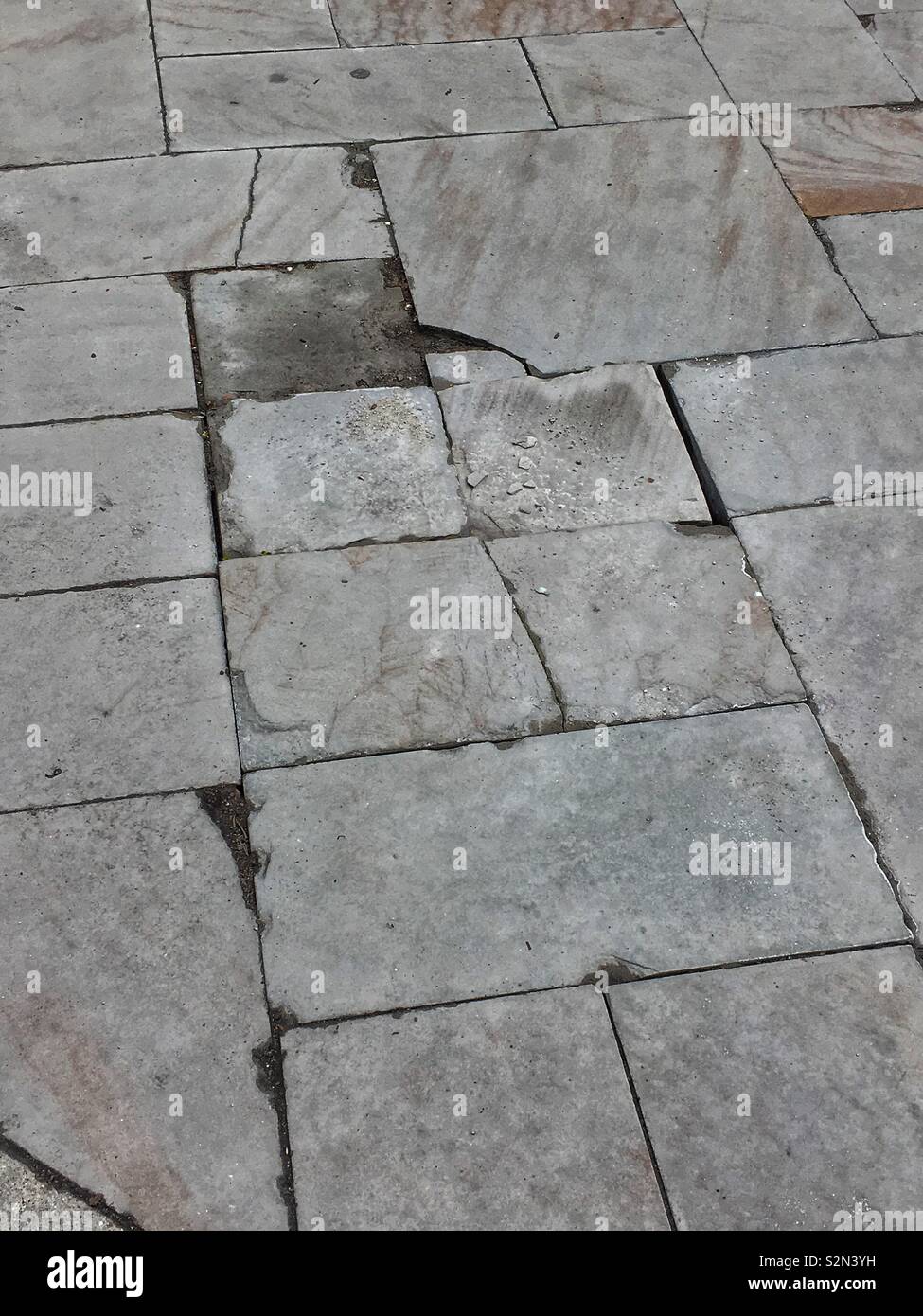 Unusual centuries old slate sidewalk pavers create an abstract design. - Smartphone Captured Stock Image