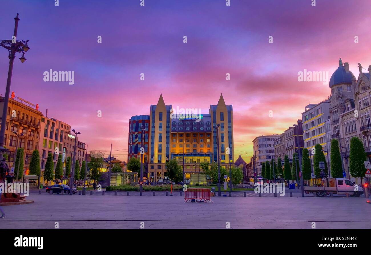 Queen Astrid place, Antwerp, Belgium in March 2019. Dramatic and colorful sunrise sky over the hotel and queen Astrid place - Smartphone Captured Stock Image