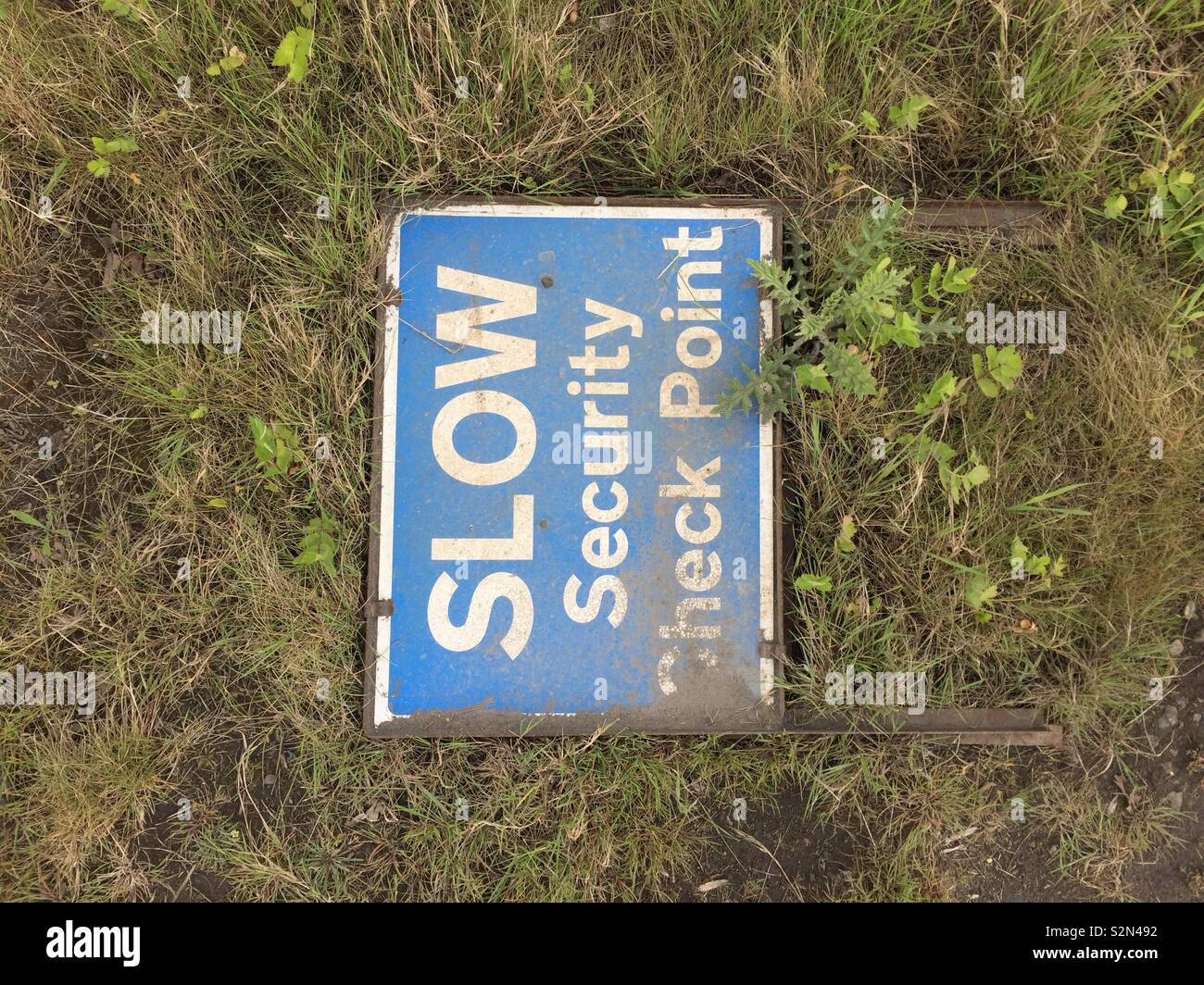 Abandoned SLOW Security Check Point sign - Smartphone Captured Stock Image