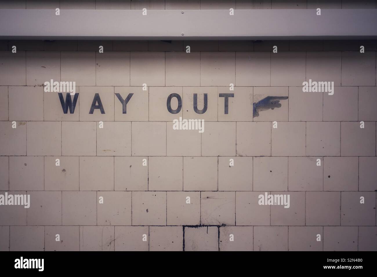 Way out. This way to exit.... writings on the wall in Melbourne, Australia. Stock Photo