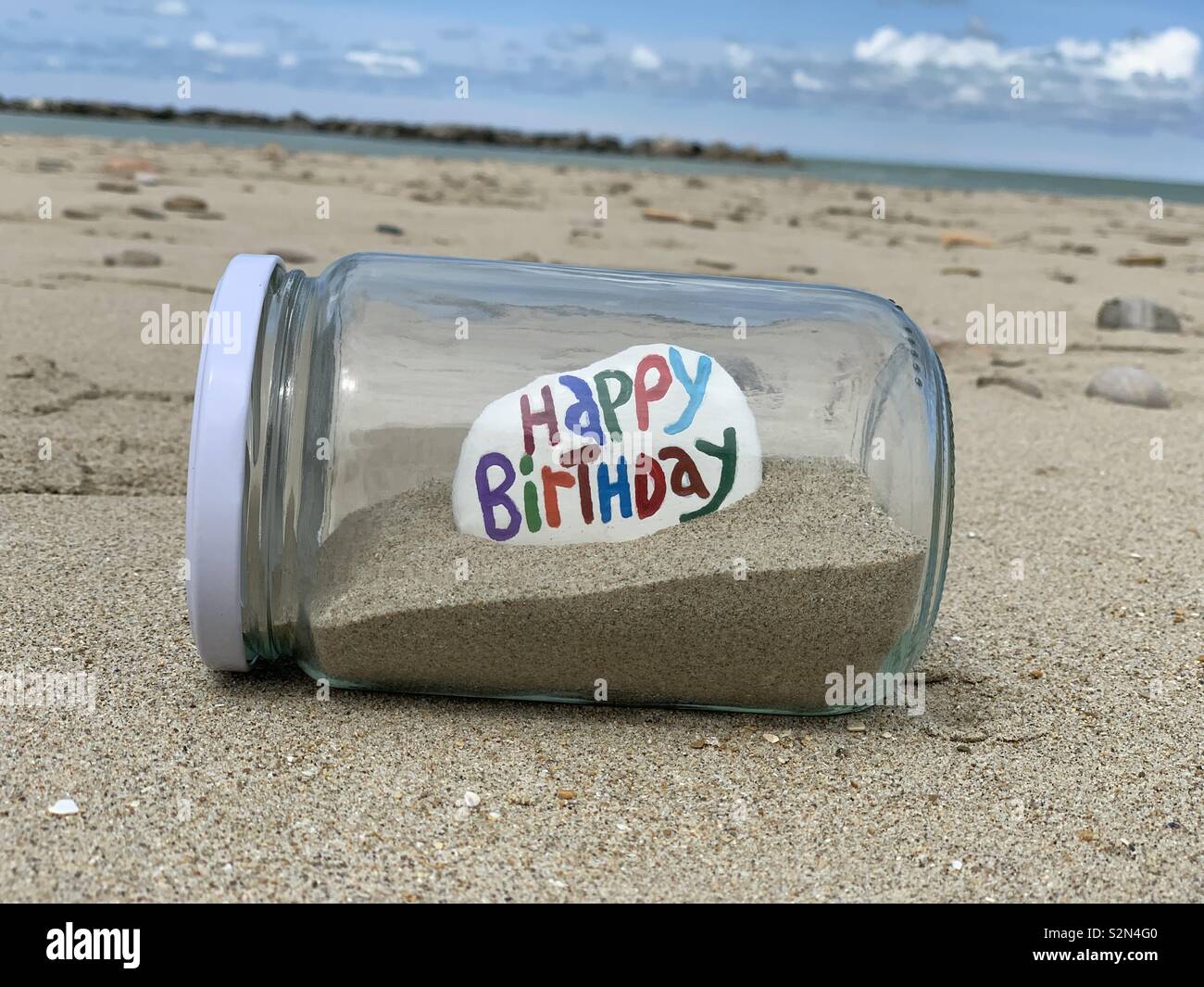 Happy Birthday Message Carved And Colored On A Stone In A Glass Jar With Sand On The Beach Stock Photo Alamy Happy Birthday Message Carved And Colored On A Stone In A Glass Jar With Sand On The Beach Stock Photo Alamy
