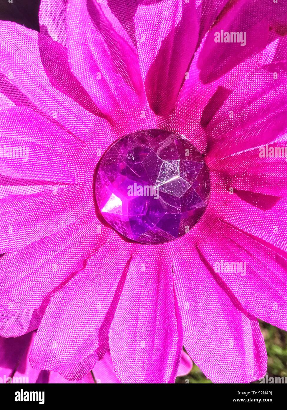 Full frame of a purple plastic flower in full bloom. Stock Photo