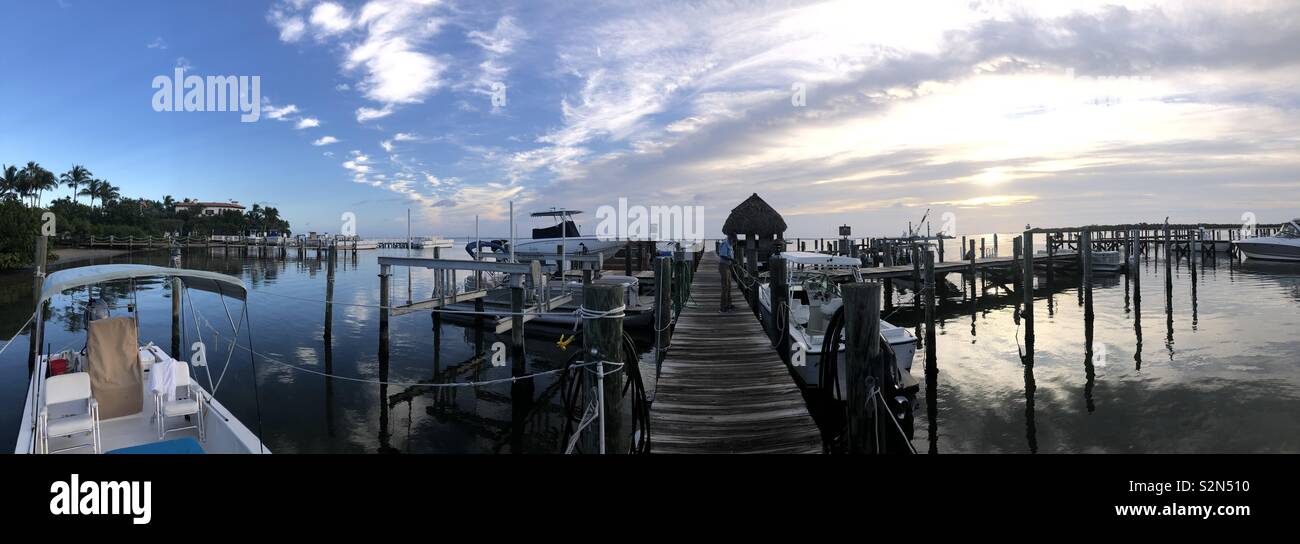 Panoramic sunrise shot of docks and water from Jensen’s Marina in Captiva FL Stock Photo