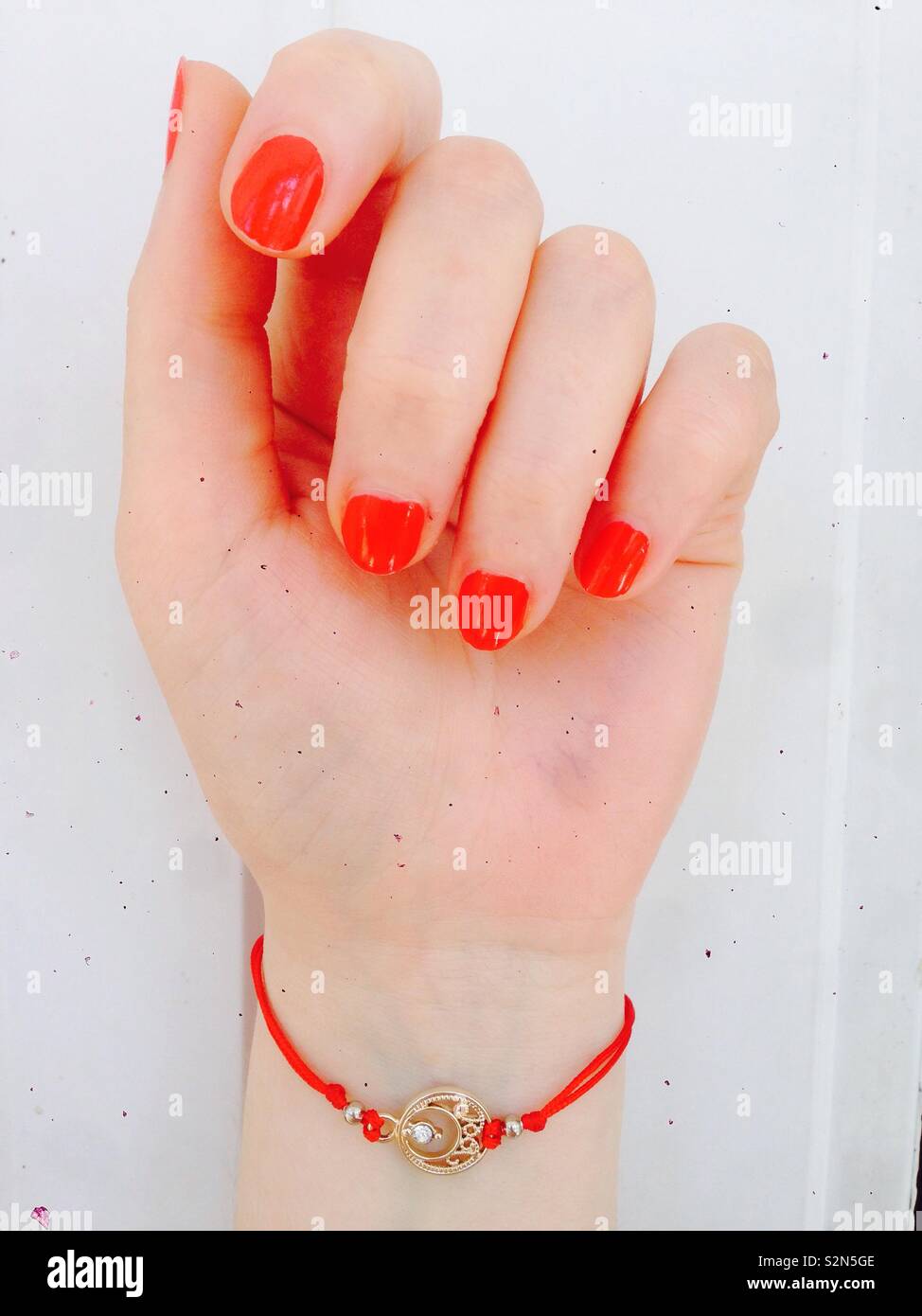 Girls hand with red nails and red beautiful jewelry Stock Photo ...