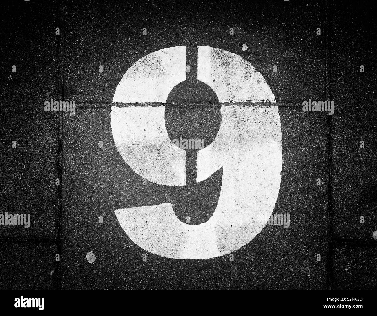 The Number Nine - stencilled and painted on the pavement of a major European City. The number after 8, but before the No. Ten. Photo © COLIN HOSKINS. - Smartphone Captured Stock Image
