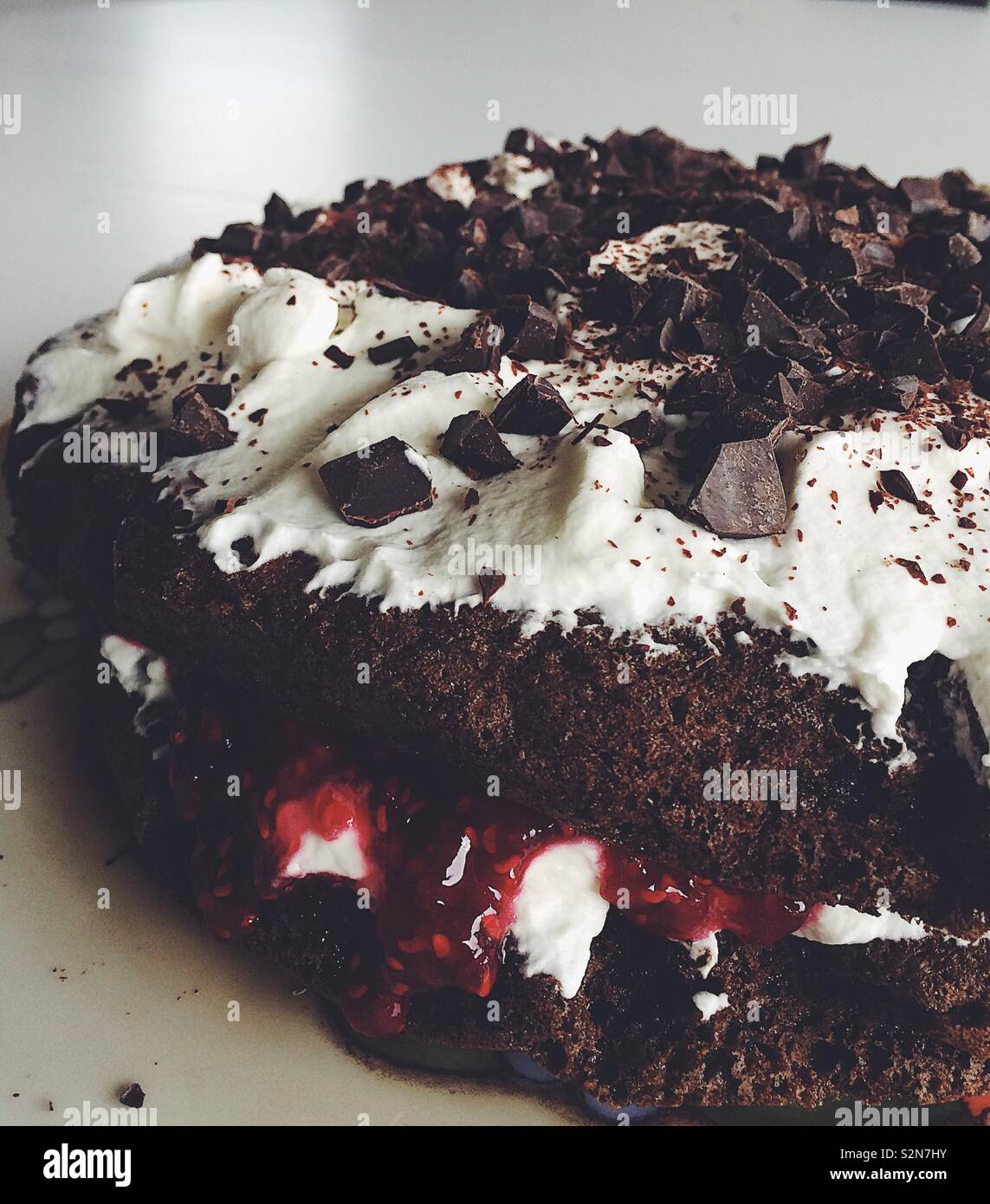 Photo of a rugbrodslagkage, typical Danish cake made with stale rye bread, chocolate, jam and whipped cream - Smartphone Captured Stock Image