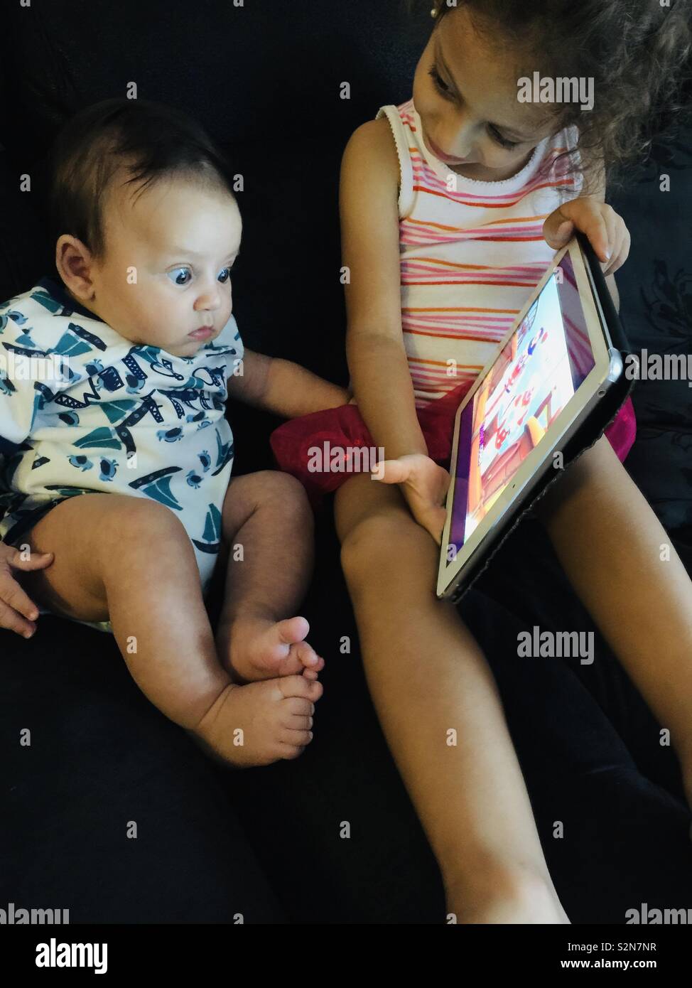 Baby discovering an Ipad. - Smartphone Captured Stock Image