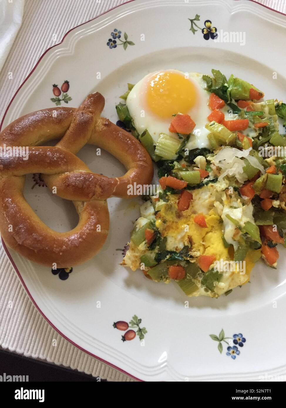 Soft Pretzel with eggs and veggies Stock Photo