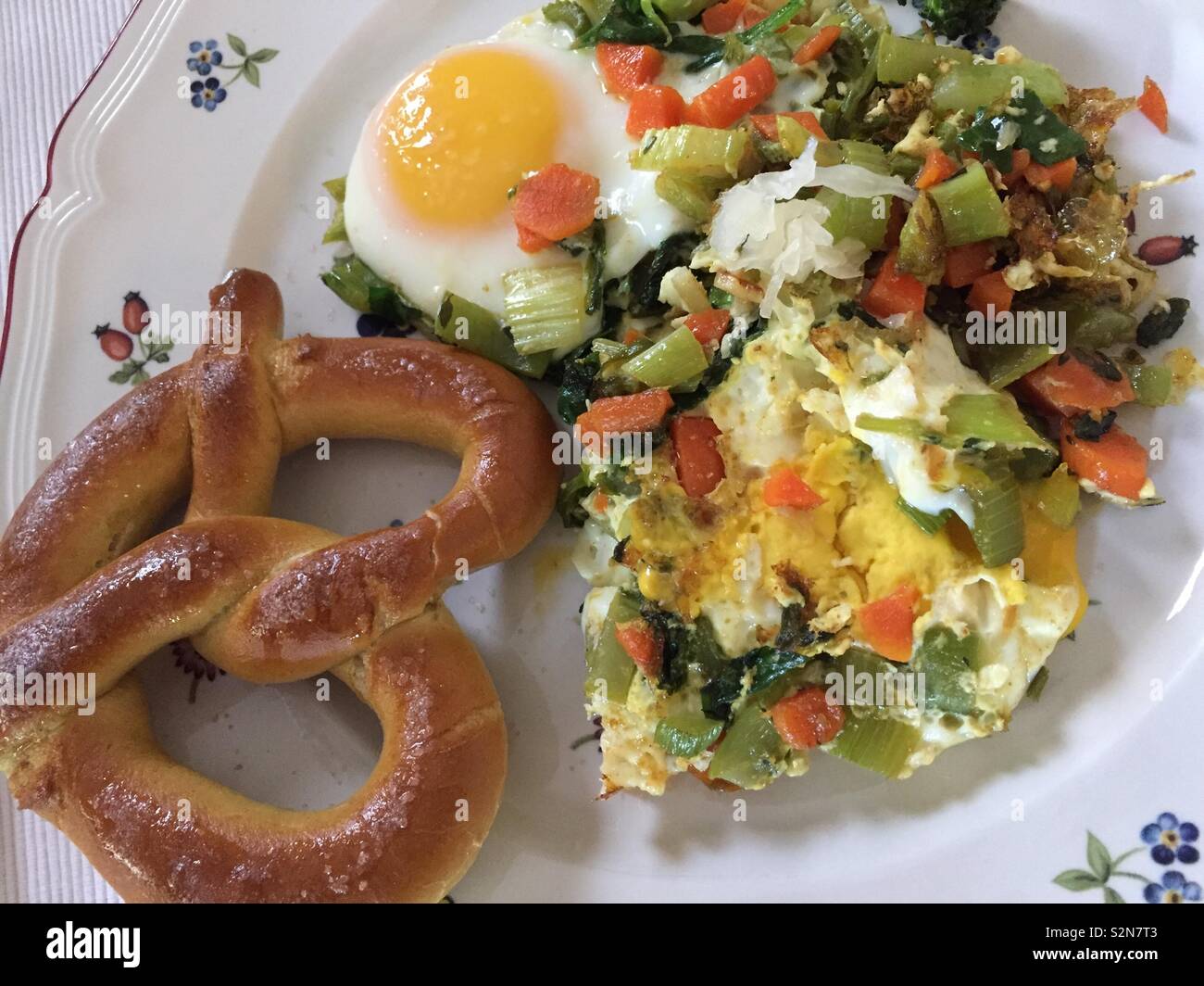 Soft pretzel and eggs with veggies Stock Photo