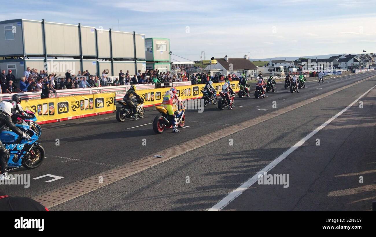 Motorcycle road racers sitting on the starting grid ready to race at the famous North West 200 in Northern Ireland. Stock Photo