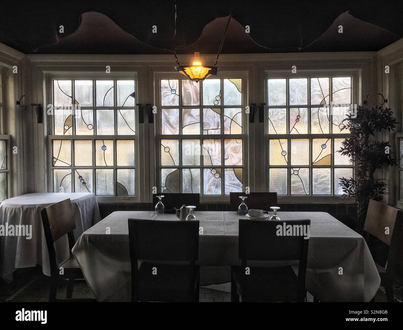 Romantic dining enclave in a farmhouse restaurant. - Smartphone Captured Stock Image