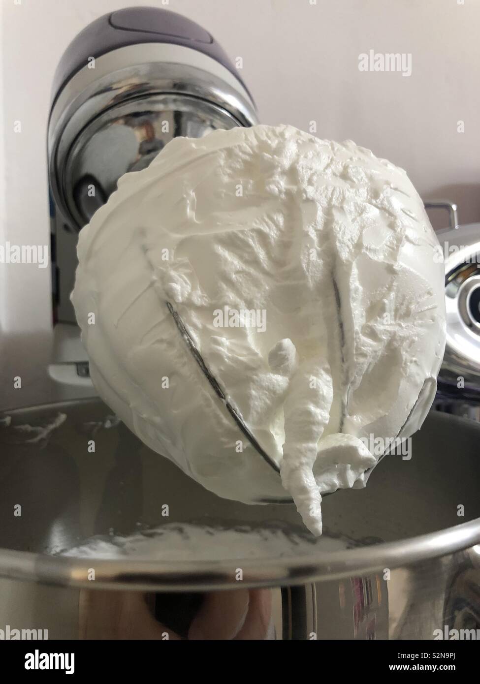 Whipped egg whites steady on the mixer hook. - Smartphone Captured Stock Image