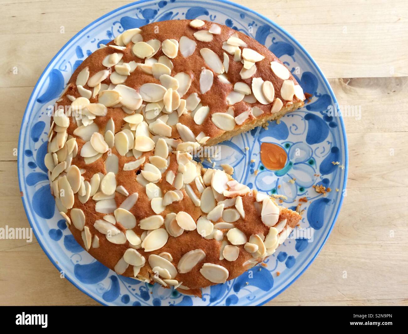 Almond cake with a slice taken out - Smartphone Captured Stock Image