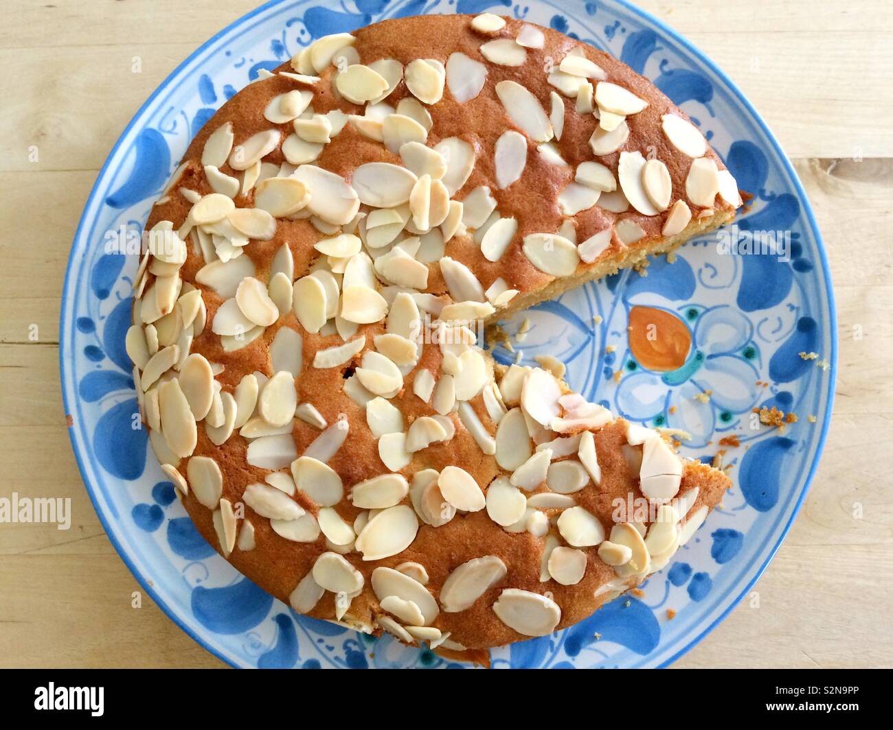 Almond cake with a slice missing - Smartphone Captured Stock Image