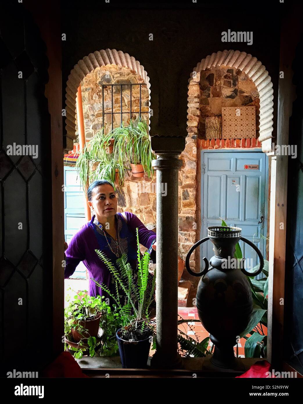 A female tourist visits the Arab House-Museum in Caceres, Extremadura, Spain - Smartphone Captured Stock Image