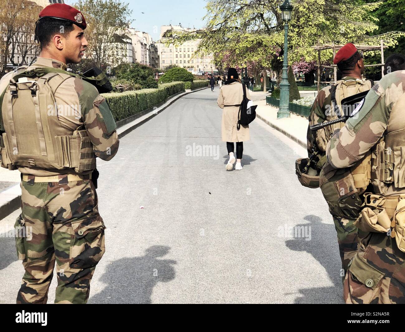 Armed soldiers in camouflage patrolling streets of Paris - Smartphone Captured Stock Image