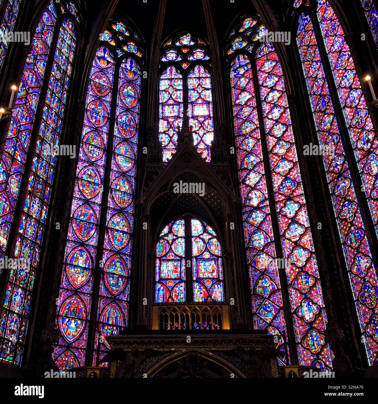 Stained glass windows behind the altar inside magnificent Sainte Chapelle, a royal chapel in the Gothic style, within the medieval Palais de la Cité, the residence of the Kings of France Stock Photo