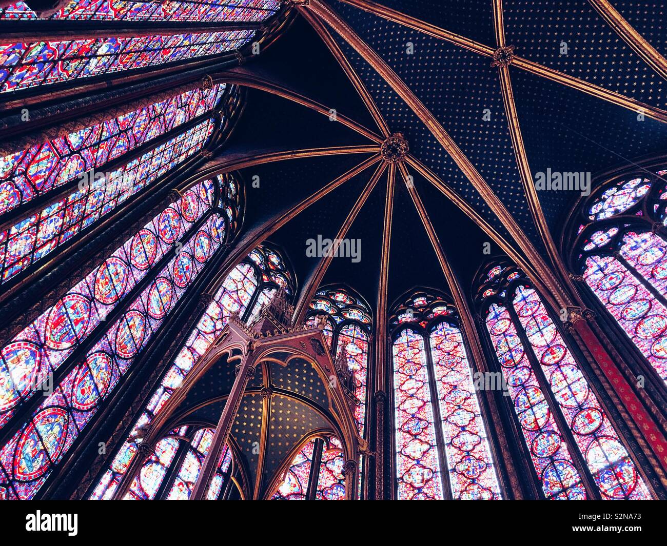Stained glass windows and ceiling of the magnificent Sainte Chapelle, a royal chapel in the Gothic style, within the medieval Palais de la Cité, the residence of the Kings of France Stock Photo