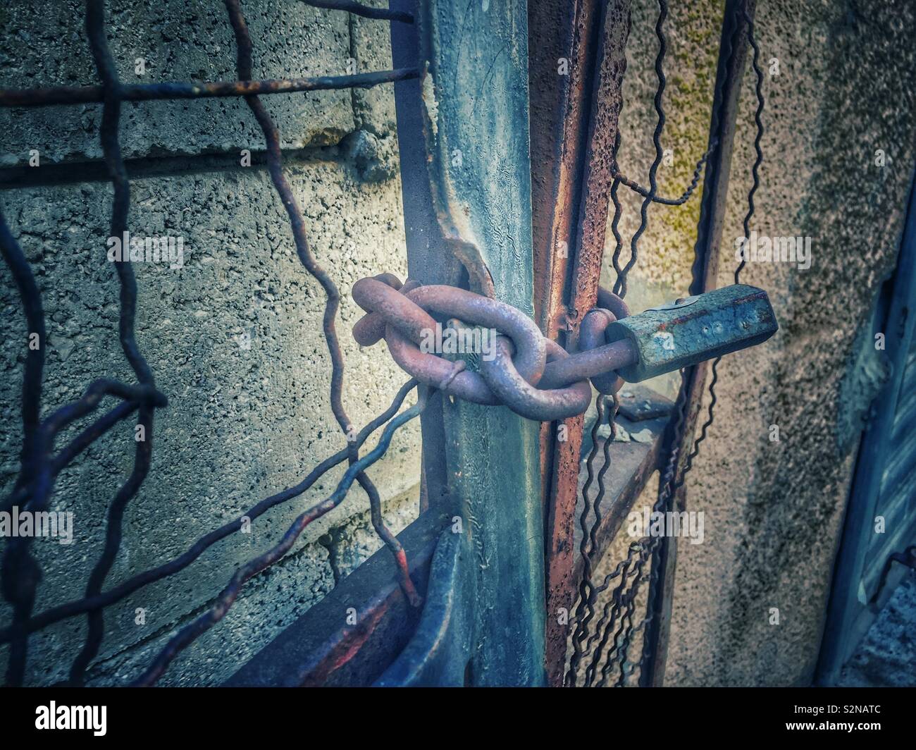 Broken gate locked with rusty chain - Smartphone Captured Stock Image