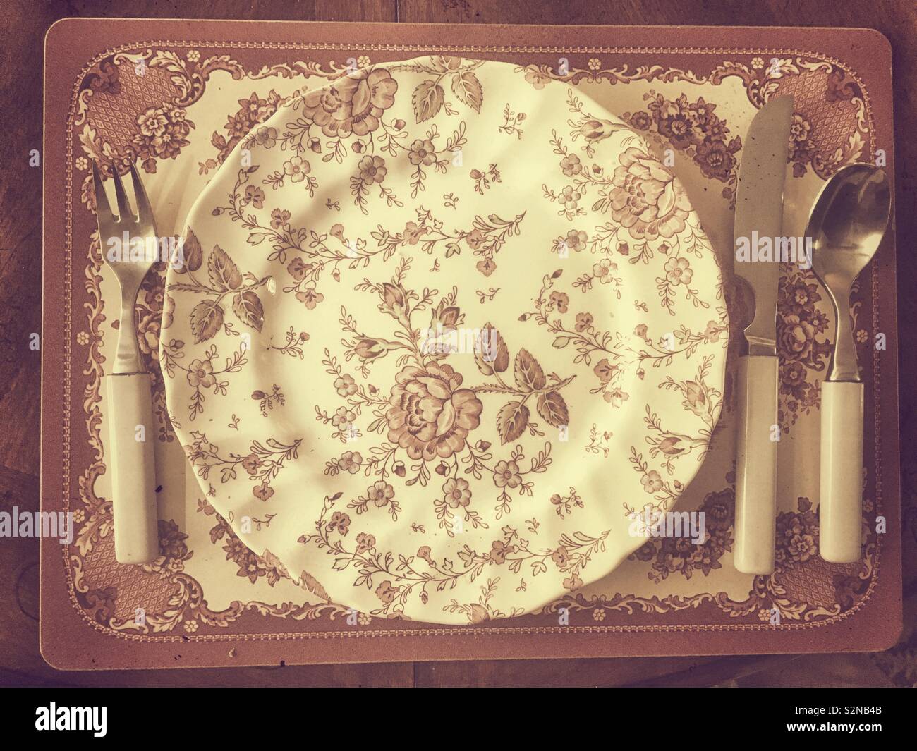 Old fashioned English China dinnerware with silverware - Smartphone Captured Stock Image