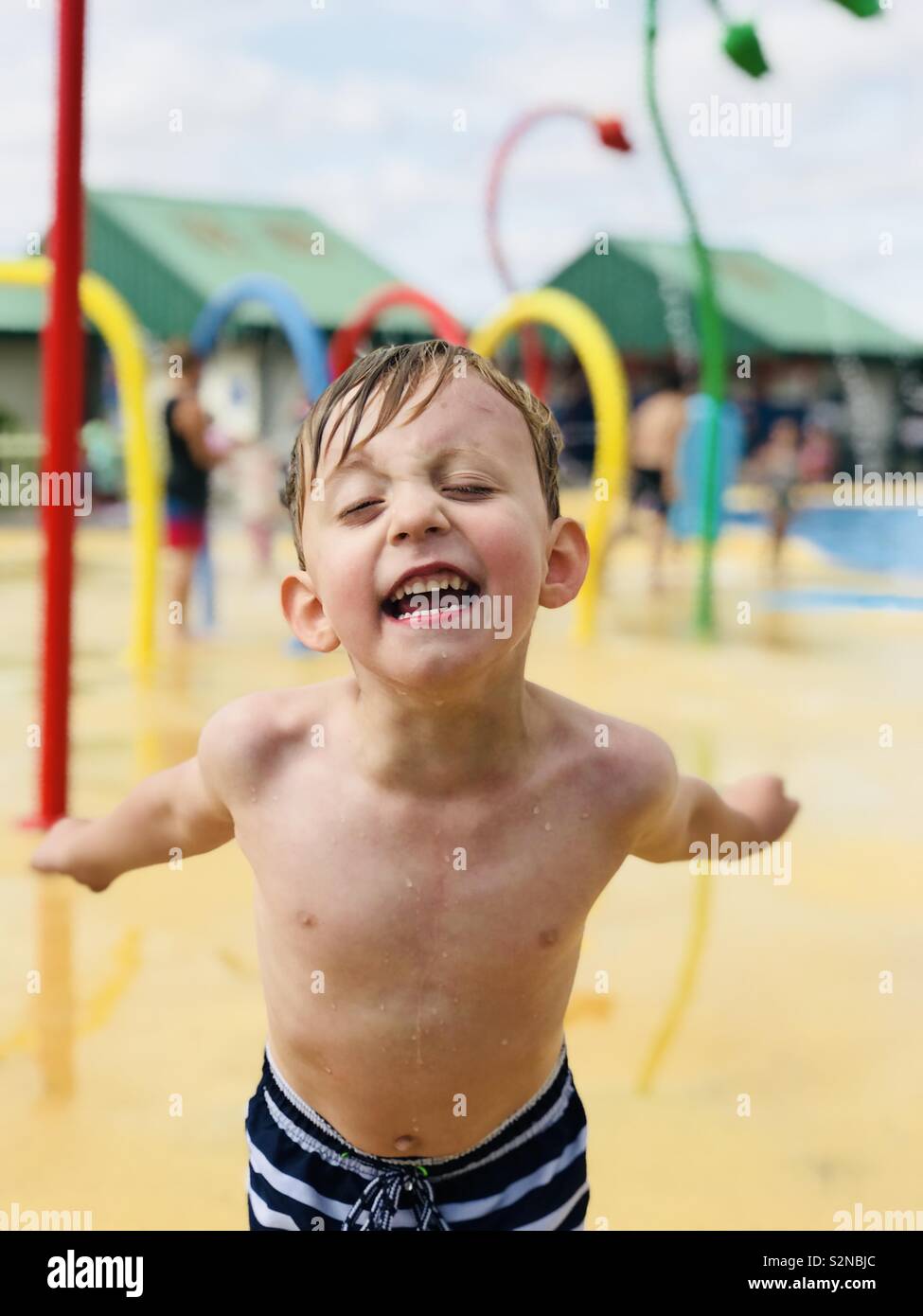 Child playing in outdoor waterpark, Mablethorpe, Lincolnshire Stock Photo
