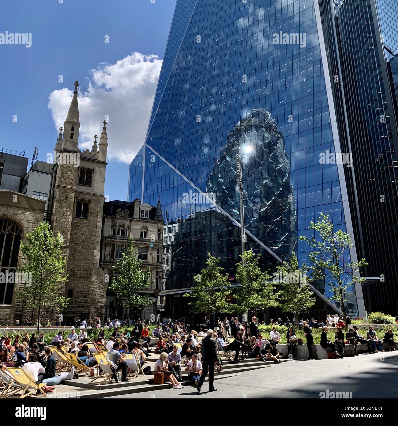 London, UK - 21 May 2019: City workers enjoying lunch al fresco on a bright sunny day. - Smartphone Captured Stock Image
