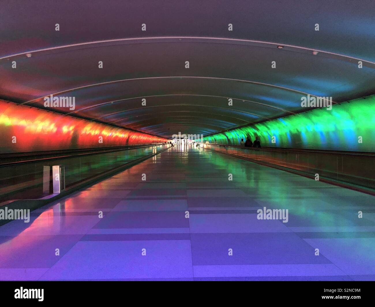 Air travel, transportation hub Detroit airport tunnel of red and green light and people mover - Smartphone Captured Stock Image