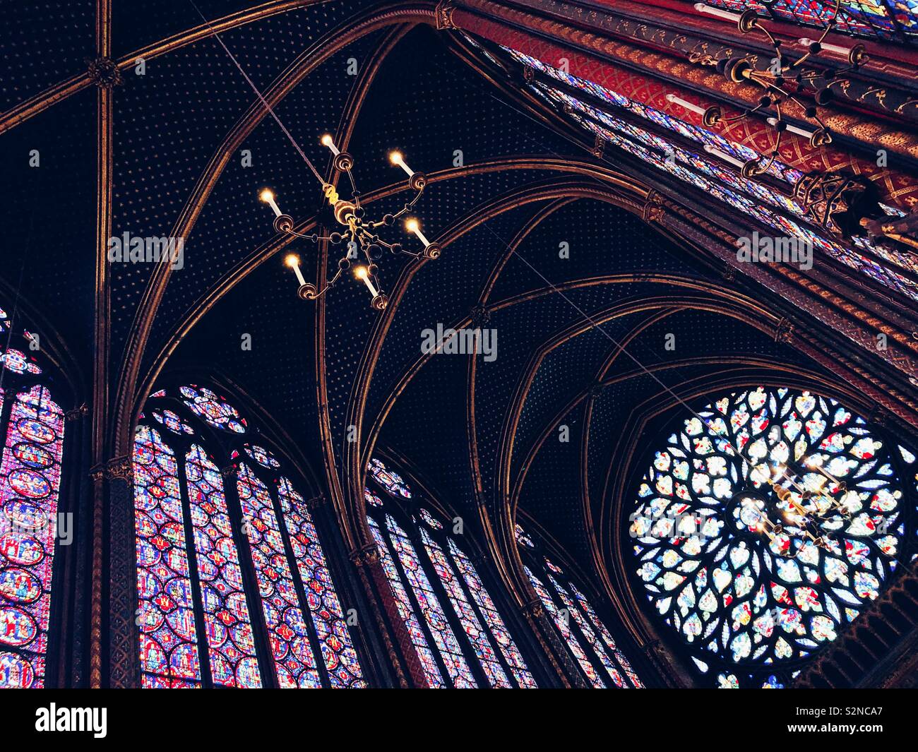 Stained glass windows and ceiling of the magnificent Sainte Chapelle, a royal chapel in the Gothic style, within the medieval Palais de la Cité, the residence of the Kings of France - Smartphone Captured Stock Image
