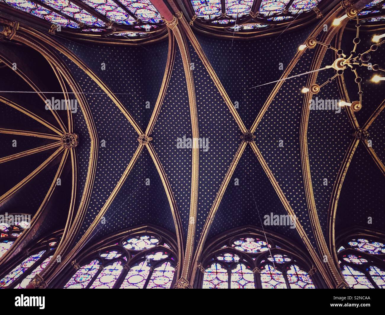 Stained glass windows and ceiling of the magnificent Sainte Chapelle, a royal chapel in the Gothic style, within the medieval Palais de la Cité, the residence of the Kings of France - Smartphone Captured Stock Image