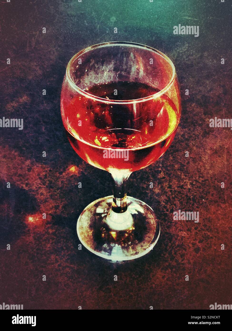 Glass of red wine illuminated by light Stock Photo